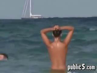 Naked young woman Gets Wet Outdoors At A Beach